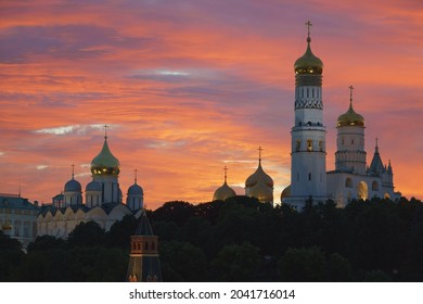 Moscow downtown. Kremlin Tower,  Ivan the Terrible Bell-Tower, Dormition Cathedral. Beautiful view. Landmark in capital of Russian Federation during pink sunset. Sutable for touristic guide, postcard
