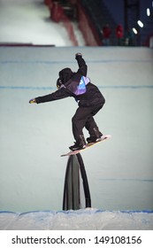 MOSCOW - FEB 16: Guy On Snowboard Slides On The Rail In The Contest BGV 2013 Grand Prix De Russie In Russian Exhibition Center On February 16, 2013 In Moscow, Russia.