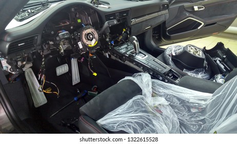 Moscow. February 2019. Premium Car Repair. Disassembled Car Interior Porsche 911. Repairing Electronics, Troubleshooting.