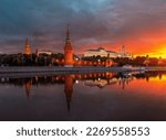 The Moscow Kremlin at dawn. A ship on the Moscow River. Beautiful sunrise in the city. Classic view of the Kremlin. the attraction of the capital. Vodovzvodnaya Tower and Kremlin Embankment