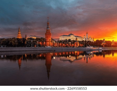 The Moscow Kremlin at dawn. A ship on the Moscow River. Beautiful sunrise in the city. Classic view of the Kremlin. the attraction of the capital. Vodovzvodnaya Tower and Kremlin Embankment