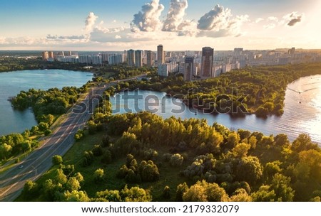 Moscow landscape at sunset, Russia. Scenic aerial view of Strogino district in Moscow northwest. Scenery of Moskva River bays and park in summer. Moscow skyline with road from Stroginsky Bridge.