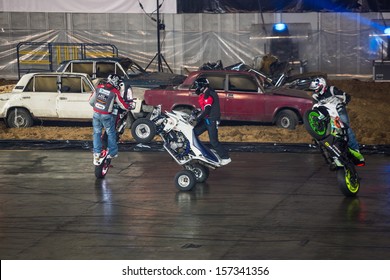 MOSCOW - MAR 23: Three Stuntmen Rides On The Rear Wheel Of Bikes On Show Monster Mania In Olimpiyskiy In March 23, 2013 In Moscow, Russia.