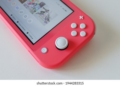 MOSCOW - MAR 27, 2021: Nintendo Switch Lite In Coral Pink Colour