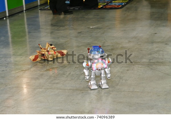 MOSCOW - MARCH 16: Toy robot and a tank\
transformer on the radio control presented at the International Toy\
Specialized Exhibition March 16, 2011 in\
Moscow