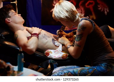 MOSCOW - MAY 20: Tattoo artist works in club ARENA-MOSCOW during V Moscow International Tattoo Convention 2012, May 20, 2012, Moscow, Russia. Convention was organized by Tattoo Studio Angel.
