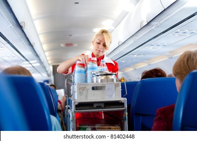 MOSCOW - MAY 28: Unidentified air hostess of "Aeroflot" serves drinks out on board from Irkutsk to Moscow, May 28, 2011. "Aeroflot", the national carrier, leads in growth rate in 2011, Moscow, Russia.