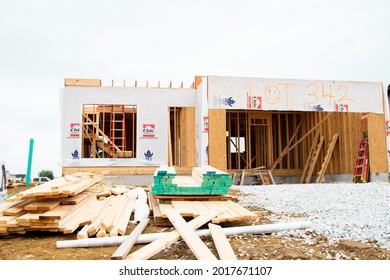 MOSCOW MILLS, MISSOURI - July 30, 2021: A New Construction Home In A Master Plan Community Sits Almost Fully Framed With Lumber Sitting In The Yard During The Competitive Housing Market.