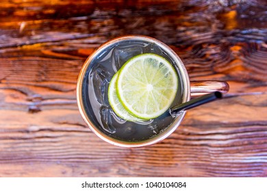 Moscow Mule Alcoholic Mixed Drink On Wooden Table Bar From Above Sliced Lime Lemon In Copper Mug Vodka 