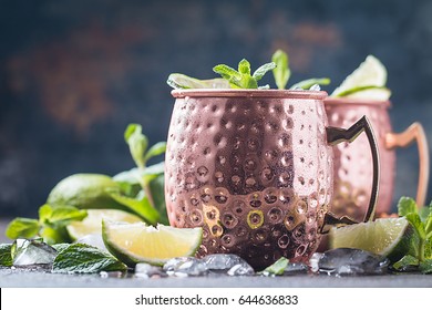 Moscow Mule Cocktail In Copper Cup With Lime, Ginger Beer, Vodka And Mint Garnish