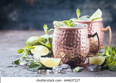 Moscow Mule Cocktail In Copper Cup With Lime, Ginger Beer, Vodka And Mint Garnish