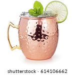 moscow mule cocktail in a copper mug garnished with lime and mint leaves