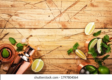 Moscow Mule Cocktail In Copper Mug With Lime, Ginger Beer, Vodka And Mint. Wooden Table, Top View, Copy Space