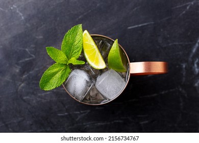 Moscow Mule Cocktail In Copper Mug With Fresh Mint And Lime. Dark Marble Background. Close Up. Top View.