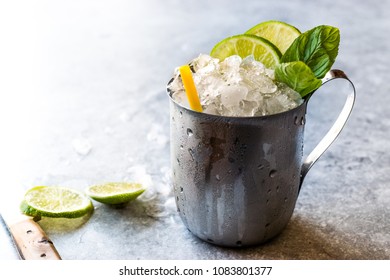 Moscow Mule Cocktail With Lime, Mint Leaves And Crushed Ice In Metal Cup / Mint Julep