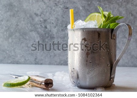 Moscow Mule Cocktail with Lime, Mint Leaves and Crushed Ice in Metal Cup. Summer Beverage.