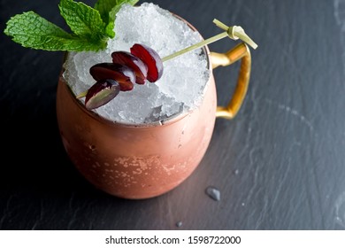 Moscow Mule Cocktails. American Cocktail made with vodka, spicy ginger beer, lime juice and garnished with a slice or wedge of lime and mint. Classically served in a copper mug.  - Powered by Shutterstock