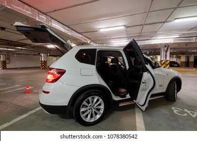 MOSCOW - NOV 17, 2017: White BMW Car With Open Doors Standing At Underground Parking, Side View.