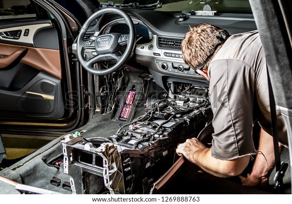 Moscow.
November 2018. A mechanic repairs an Audi ... Repairing wiring,
gearboxes, disassembled interior premium crossover. Removed chairs.
Leather interior. Neat repair service
center.