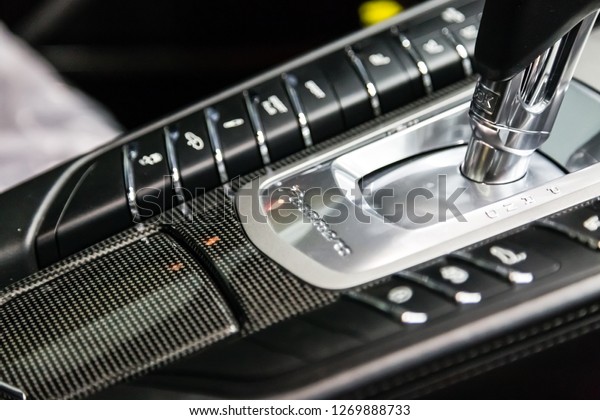 Moscow.\
November 2018. The shift knob of the full-size luxury car Porsche\
Panamera Turbo. Carbon panel with logo,\
shiftgear