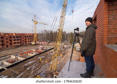 Moscow Region - Circa November, 2012: View of photographer taking shots of construction site of apartment building during cold winter weather - Shutterstock ID 1784610620