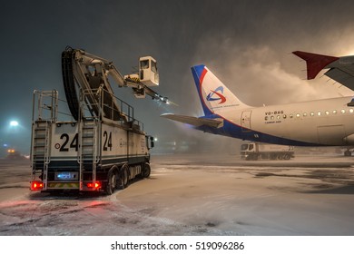 Moscow region, Domodedovo, Russia - January 16, 2016: De-icing of passenger aircraft Airbus A320 VQ-BAG Ural airlines at Domodedovo international airport at night..