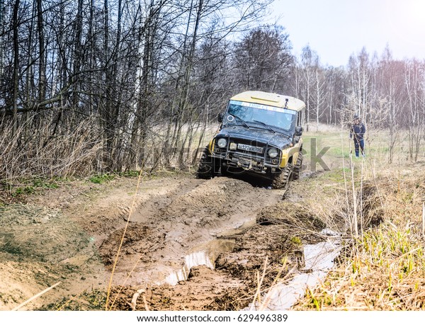 Moscow region, Russia. 04.21.2017. The sport\
utility vehicle (SUV) is driving in the forest near the town of\
Bronnitsy, Moscow region, Russia, April 21, 2017. The yellow car.\
Photo with lens flare