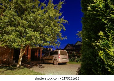 Moscow Region. Russia. July 2, 2022. Minivan Opel Combo Life In The Yard Of A Country House Among The Trees On A Summer Night.