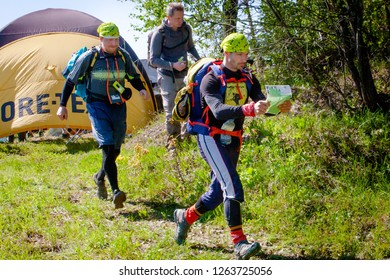 Moscow Region, Russia- May 14, 2016: Orienteering Trail Competitions. Participants Of Competitions.TrailO. Athletes Run, Guided By Topographic Map