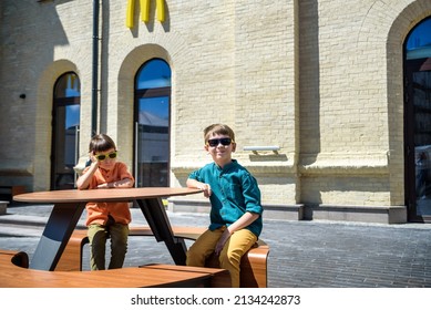 Moscow, Russia - 02 May 2022: McDonald's Restaurant Logo In Moscow. McDonald's Is An American Hamburger And Fast Food Restaurant Chain. Two Boys Sad That No Service Anymore.