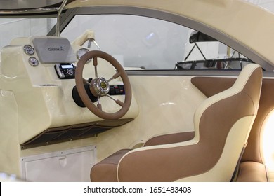 Moscow / Russia – 03 08 2017: Modern Russian cabin motor boat Enigma 600 interior close up Captain seat, dashboard and steering wheel in cockpit on Moscow Boat Show 2017 exhibition in Crocus Expo