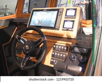 Moscow / Russia – 03 08 2018: Dashboard, Simrad Chartplotter Monitor, Steering Wheel On сaptain's Control Room Cabin Motor Boat At The Russian Yacht Exhibition Moscow Boat Show MBS 2018 In Crocus Expo