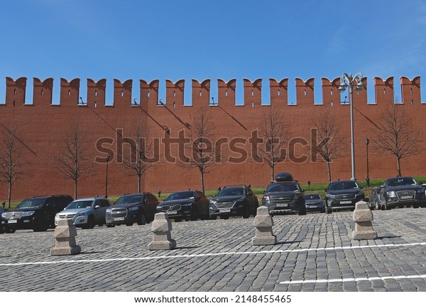 Moscow, Russia - 04.20.2022: Cars parked on\
Vasilyevsky Spusk by the Kremlin wall. Parking for visitors to\
Zaryadye Park, Red Square and other tourist attractions around the\
Moscow Kremlin.