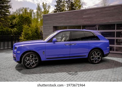 Moscow, Russia - 05.14.2021: Luxury Rolls Royce Cullinan Black Badge Neon Nights color SUV limited edition in the modern country estate. 
