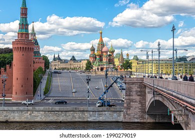 Moscow, Russia, 05.25.2021. View from the Bolshoy Moskvoretsky Bridge to Red Square, the Kremlin Wall, St. Basil's Cathedral, the Gum building and Vasilievsky Descent against the blue sky with clouds