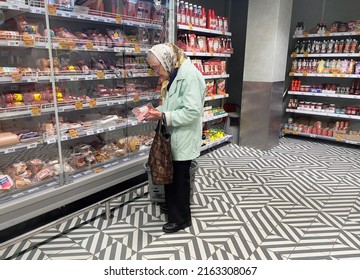 Moscow, Russia - 06.02.2022: Retired Woman Reads Information About The Sausage In The Meat Products Department In The Grocery Store. Inflation, Price Increase, Affordable Food Concept.