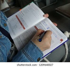 Moscow, Russia, 06.04.2018, Studying In The Train, Hands Showcase, Russian/Turkish Language Study Book