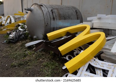 Moscow, Russia - 06.21.2022: McDonalds Logo Letter Character M In Dirty Rubbish Heap Dump Trash Litter Garbage. Fast Food And Sanctions Concept. Environment Issues