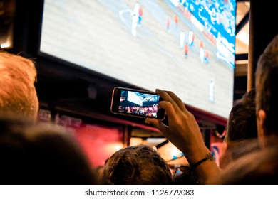 Moscow / Russia - 07 01 2018 : Nikolskaya Street Football Fan Zone. TV translation. Hand taking pictures on the smartphone