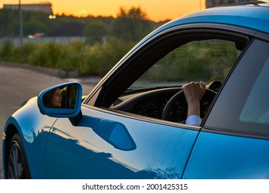 Moscow, Russia 07-02-02019 Porsche 911 Carrera 4S (Miami Blue) 992 Sports Beautiful Caucasian Woman Car Goes Away Into The Distance In The Sun And Sun Rays. Sports Car Is Driving In The Parking Lot. 