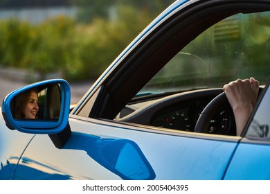 Moscow, Russia 07-02-02019 Porsche 911 Carrera 4S (Miami Blue) 992 Sports Beautiful Caucasian Woman Car Goes Away Into The Distance In The Sun And Sun Rays. Sports Car Is Driving In The Parking Lot. 