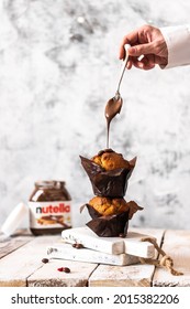 Moscow, Russia. 07-26-2021. Nutella Chocolate On Chocolate Pancake Muffins. Sweet Nut Paste With A Woman's Hand Spreading.