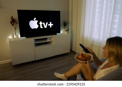 Moscow Russia - 08 08, 2022: Woman Watch The New Online Video Streaming Subscription Apple Plus On TV. Woman Holding Plate Of Chips