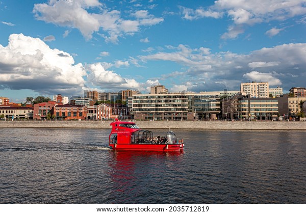 Moscow, Russia - 08.11.2021: The\
red ship sails along the Moscow river along residential\
area