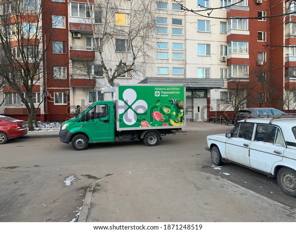 Moscow, Russia - 10 December 2020: One of the\
leading companies in Russia Perekrestok delivering grocery shopping\
to a local residential area. Translation in Russian means Grocery\
shopping delivery.