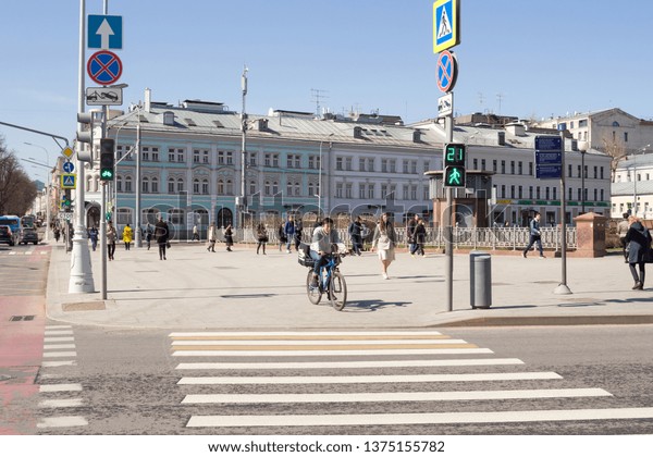 Moscow,\
Russia, 11 April, 2019: People are waiting for the green traffic\
signal at the pedestrian crossing - zebra. Crossroad Trubnaya,\
Tsvetnoy Boulevard and Rozhdestvensky\
Boulevard