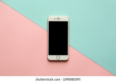 MOSCOW, RUSSIA- 11.03.2018: Blank Screen White Cellphone IPhone 7 By Apple On Diagonal Pastel Pink And Blue Background. Minimal Style, Flatlay.