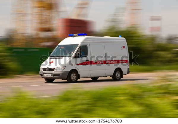 Moscow, Russia 11.06.2020: Ambulance car\
with with flashing lights running fast on the\
road