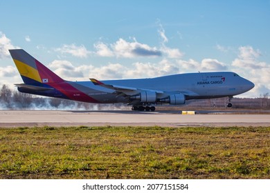 Moscow, Russia - 11.09.2021. Domodedovo International Airport.  Cargo Plane Boeing 747F (Freighter) Of Asiana Cargo Airlines Touches Down Of The Runway. The Wheels Are Smoking. Side View.