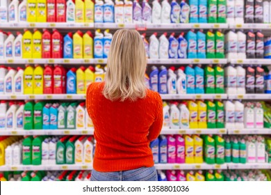 Moscow, Russia, 11/22/2018. Young woman in store chooses cleaning product. View from the back.